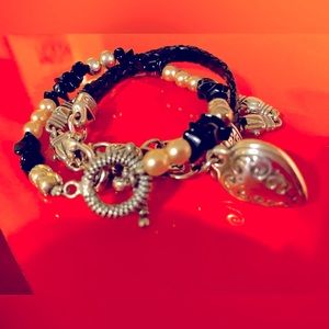 Three silver bracelets with various multi colored slides and beads.